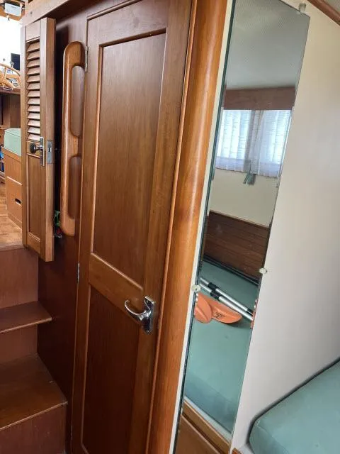 Slide: The Image of 1981 Grand Banks 36 Classic interior with wooden door and mirror, showcasing classic nautical design. - 22