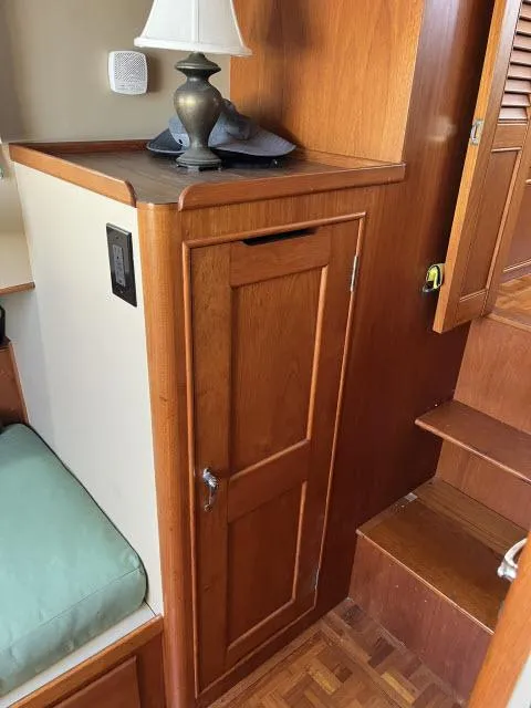 Slide: The Image of 1981 Grand Banks 36 Classic interior with wooden cabinetry and stairs. - 23