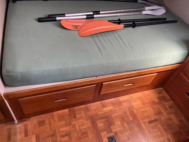 Slide: The Image of Interior of 1981 Grand Banks 36 Classic with paddles on a cushioned bench. - 25