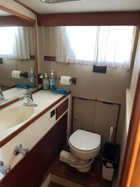 Slide: The Image of 1981 Grand Banks 36 Classic yacht bathroom with sink, mirror, and toilet. - 27