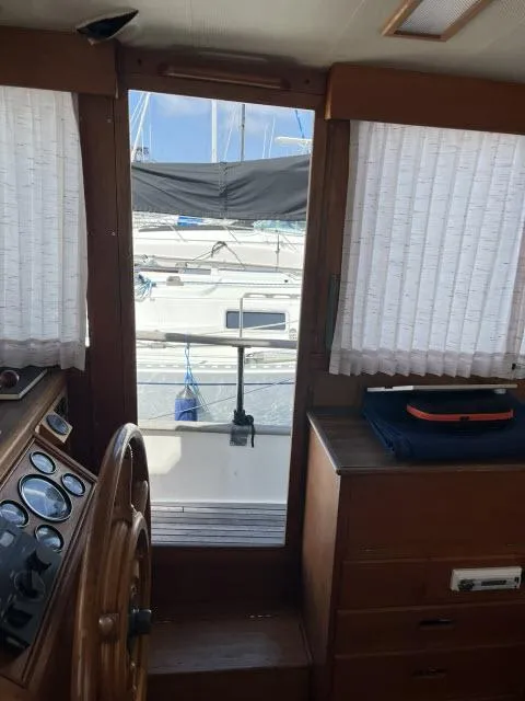 Slide: The Image of Interior view of 1981 Grand Banks 36 Classic yacht with wooden helm and curtains. - 3