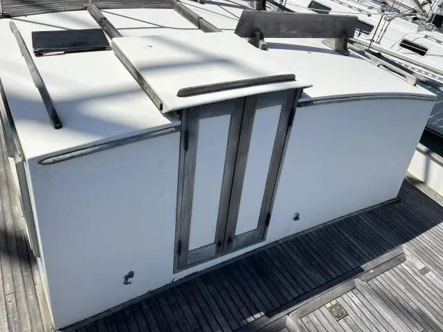 Slide: The Image of 1981 Grand Banks 36 Classic boat cabin with wooden deck and white exterior. - 31