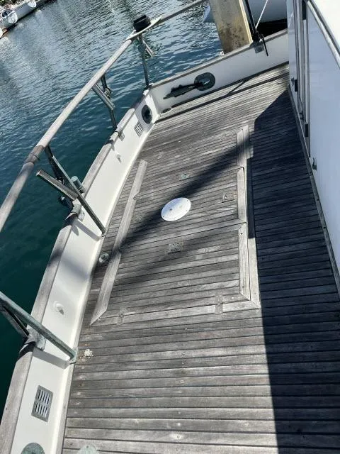 Slide: The Image of 1981 Grand Banks 36 Classic boat deck with wooden flooring and metal railings. - 33
