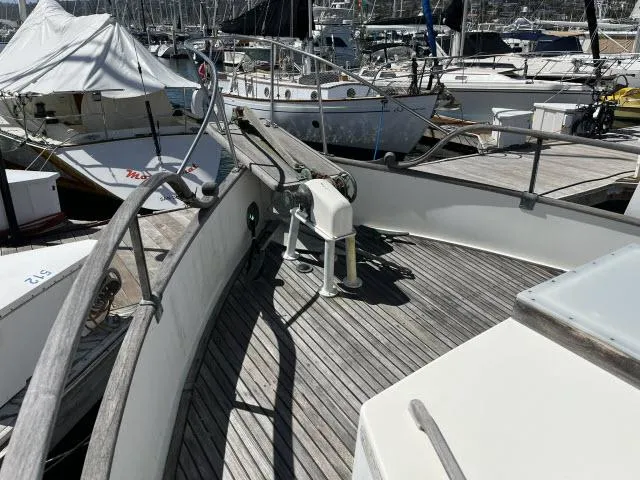 Slide: The Image of 1981 Grand Banks 36 Classic yacht docked at a marina, showcasing wooden deck and railing. - 35
