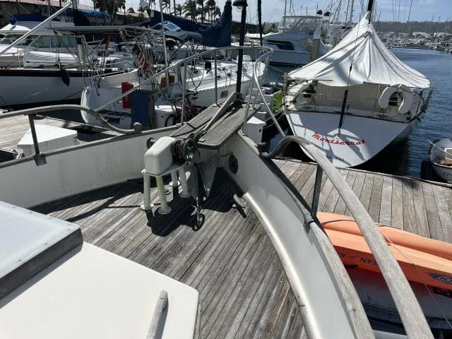 Slide: The Image of 1981 Grand Banks 36 Classic yacht docked at marina, featuring wooden deck and nautical equipment. - 36