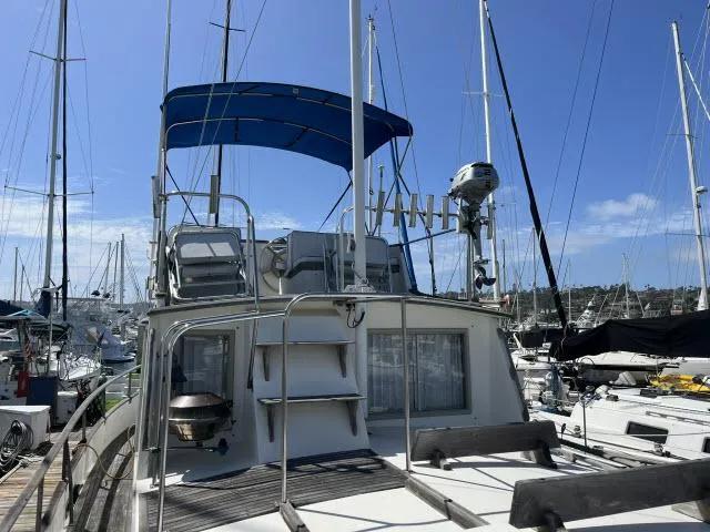 Slide: The Image of 1981 Grand Banks 36 Classic yacht docked at marina under clear blue sky. - 38