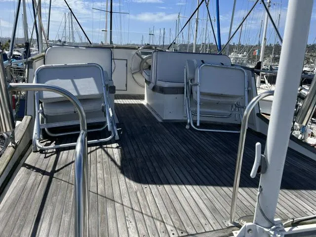 Slide: The Image of 1981 Grand Banks 36 Classic yacht deck with seating, docked in a marina. - 39