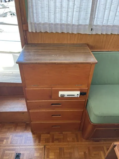 Slide: The Image of Interior of 1981 Grand Banks 36 Classic with wooden drawers and green cushioned seating. - 4