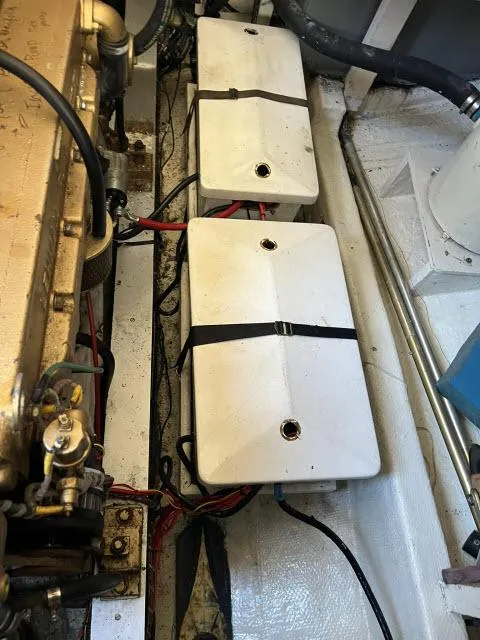 Slide: The Image of Engine compartment of a 1981 Grand Banks 36 Classic, featuring two white battery boxes. - 48