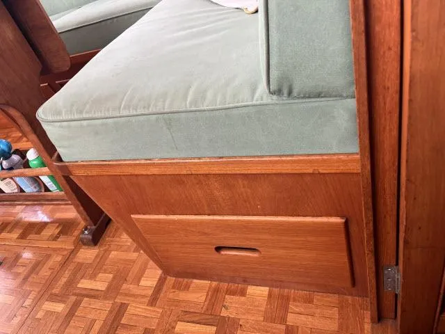 Slide: The Image of 1981 Grand Banks 36 Classic interior with wooden storage and cushioned seating. - 8