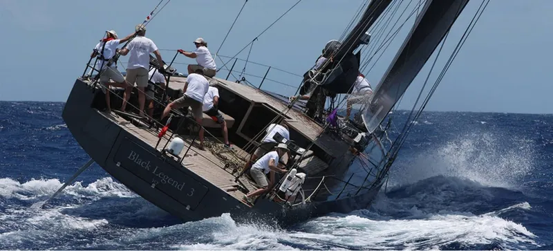 Slide: The Image of Sailboat racing on rough seas, crew in action, Black Pepper Code 2, 2025 model. - 10