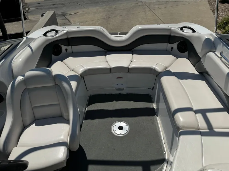 Slide: The Image of 2006 Yamaha Boats AR 210 interior with white seating and cup holders. - 13