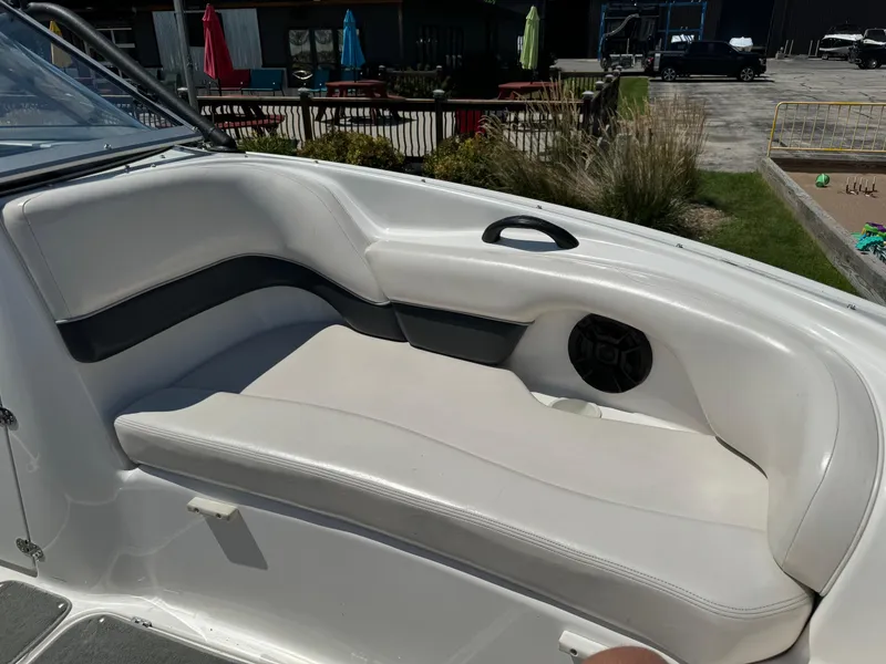 Slide: The Image of 2006 Yamaha AR 210 boat interior with white seating and speaker. - 15