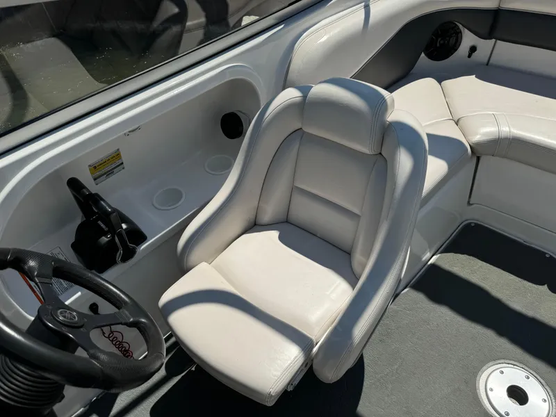 Slide: The Image of 2006 Yamaha Boats AR 210 interior with white seating and steering wheel. - 18