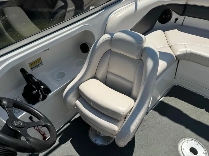Slide: The Image of 2006 Yamaha AR 210 boat interior with steering wheel and cushioned seating. - 19