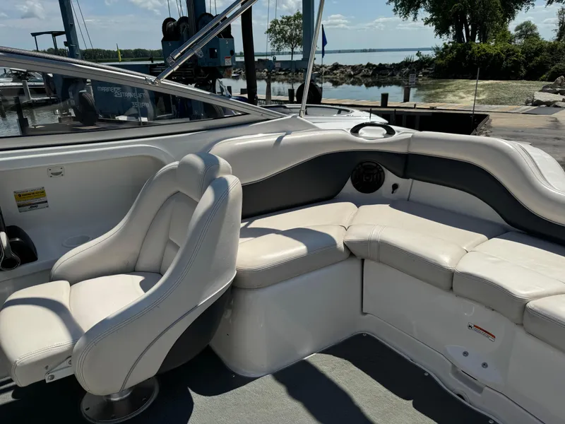Slide: The Image of 2006 Yamaha AR 210 boat interior with white seating and waterfront view. - 26