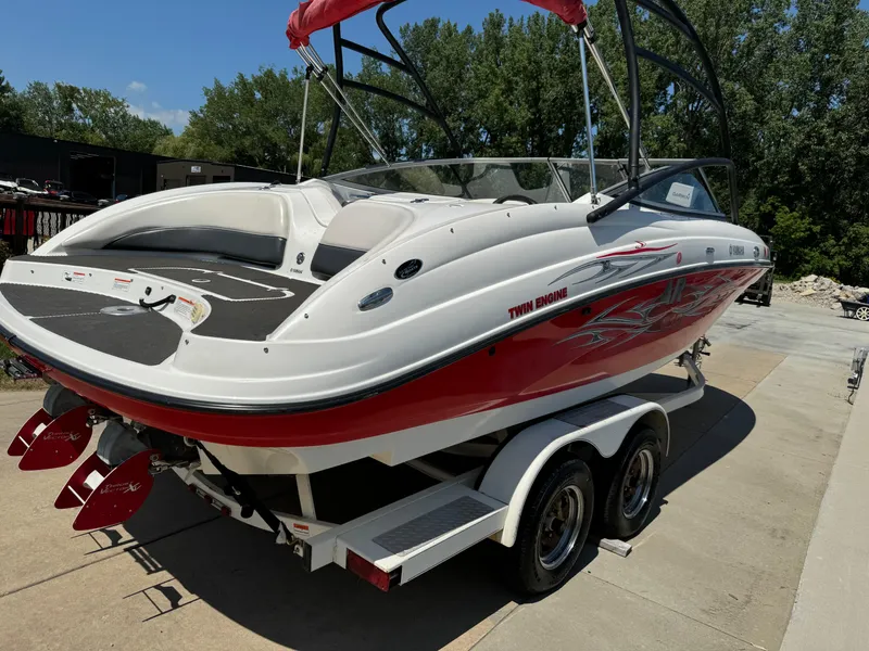 Slide: The Image of 2006 Yamaha Boats AR 210 on trailer, red and white design, parked outdoors. - 3