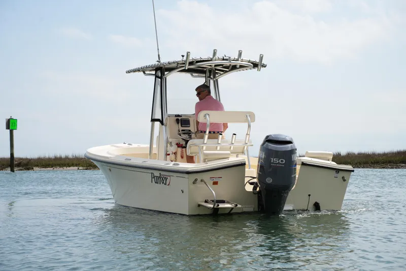 Slide: The Image of 2012 Parker 21 SE CC boat on water with outboard motor and canopy. - 10