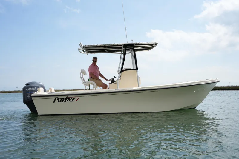 Slide: The Image of 2012 Parker 21 SE CC boat on water with Yamaha engine, clear sky background. - 11