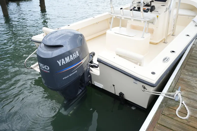 Slide: The Image of 2012 Parker 21 SE CC boat with Yamaha 150 outboard motor docked at marina. - 12