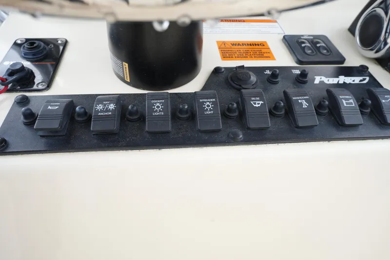 Slide: The Image of Control panel of a 2012 Parker 21 SE CC boat with labeled switches. - 18