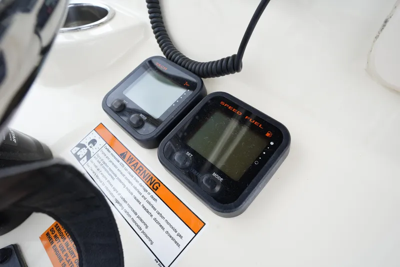 Slide: The Image of Control panel of a 2012 Parker 21 SE CC boat with speed and fuel gauges. - 19