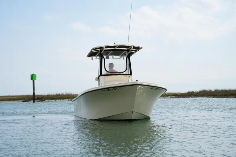 Slide: The Image of 2012 Parker 21 SE CC boat on calm water, clear sky background. - 2