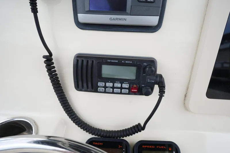 Slide: The Image of VHF marine radio and Garmin GPS on 2012 Parker 21 SE CC boat dashboard. - 20