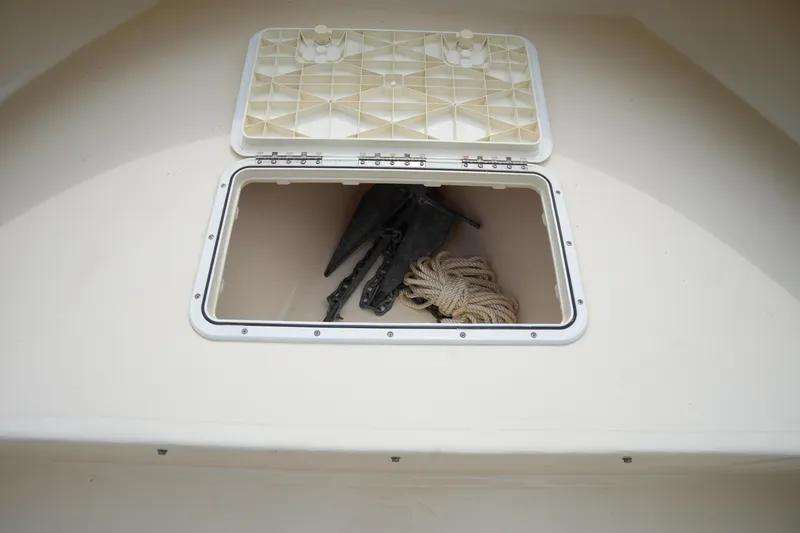 Slide: The Image of Open storage compartment on 2012 Parker 21 SE CC boat with anchor and rope. - 27