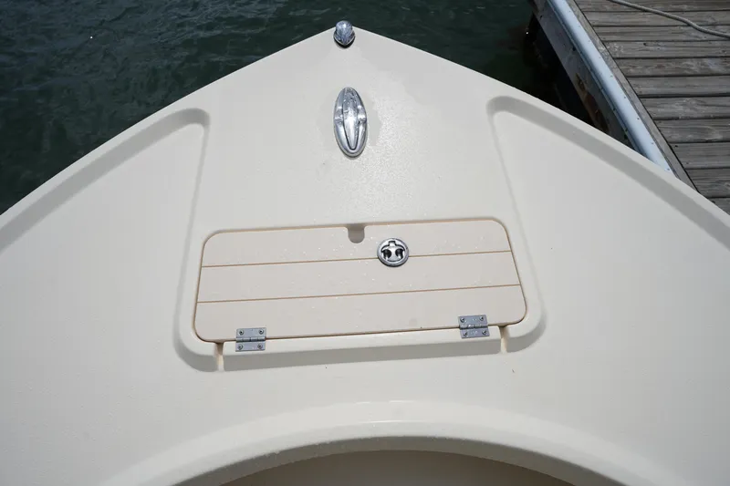 Slide: The Image of Bow of 2012 Parker 21 SE CC boat at dock, featuring storage compartment. - 28