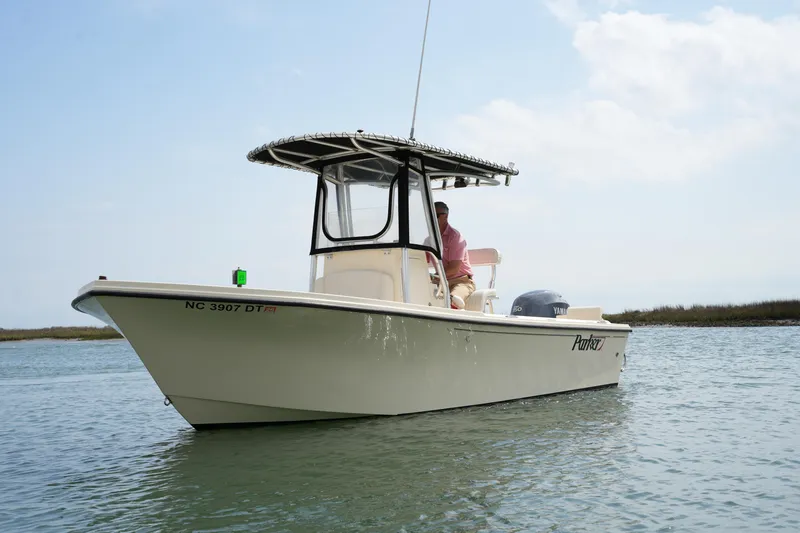 Slide: The Image of 2012 Parker 21 SE CC boat on calm water, side view. - 5