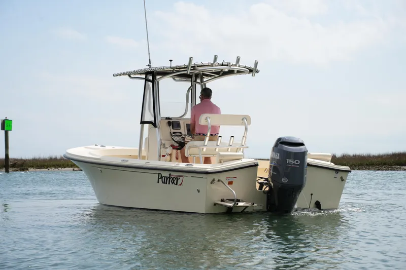 Slide: The Image of 2012 Parker 21 SE CC boat on water, rear view with outboard motor. - 9
