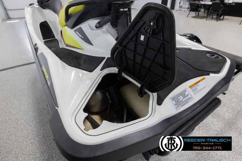 Slide: The Image of 2015 Sea-Doo 215 WAKE PRO jet ski with open storage compartment in showroom. - 10