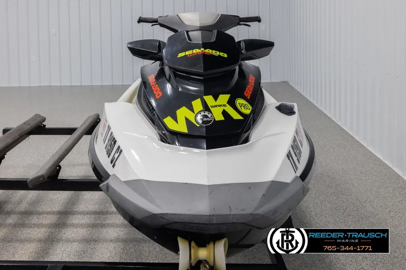 Slide: The Image of 2015 Sea-Doo 215 WAKE PRO jet ski on display in a showroom. - 3