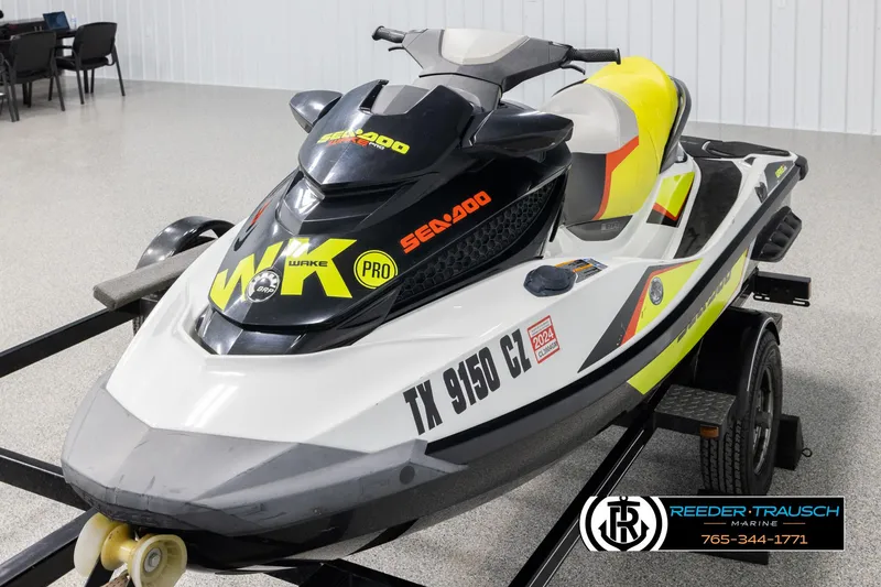 Slide: The Image of 2015 Sea-Doo 215 WAKE PRO jet ski on trailer in showroom. - 4