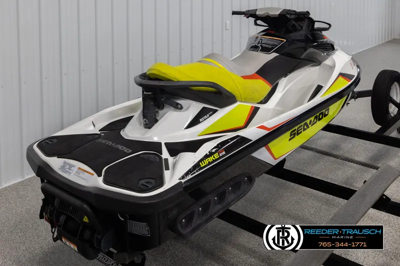 Slide: The Image of 2015 Sea-Doo 215 WAKE PRO jet ski on trailer in showroom. - 7