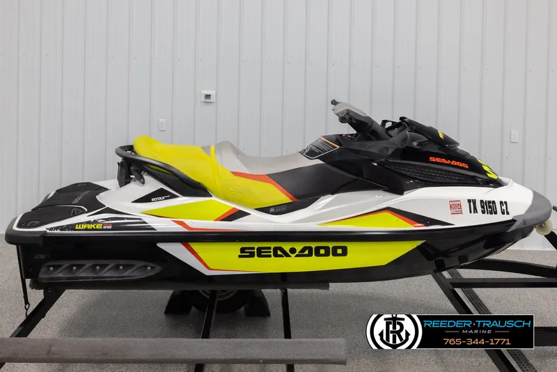 Slide: The Image of 2015 Sea-Doo 215 WAKE PRO jet ski with vibrant yellow accents on display. - 8