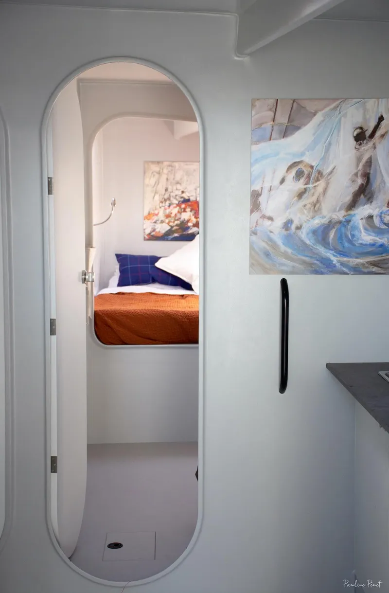 Slide: The Image of Modern yacht interior with cozy bedroom, vibrant artwork, and sleek design. Black Pepper Code 3, 2025. - 19