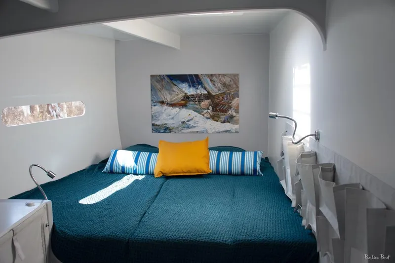 Slide: The Image of Modern boat cabin interior with cozy bed, colorful pillows, and wall art. Black Pepper Code 3, 2025. - 20