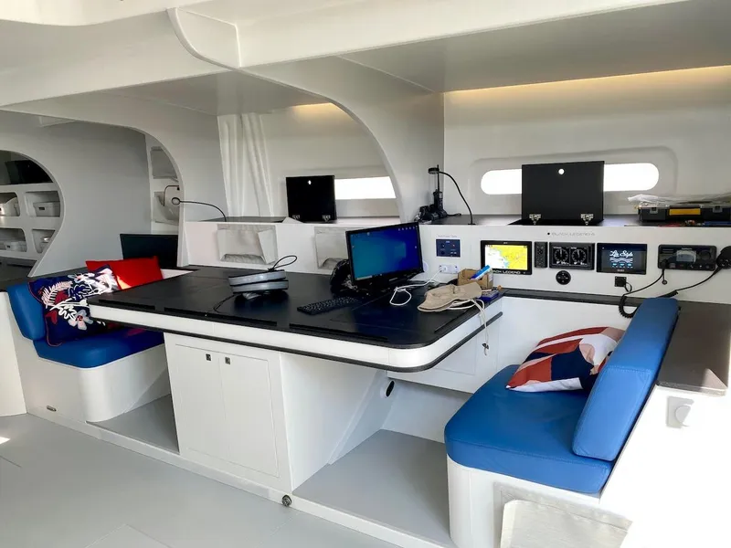 Slide: The Image of Modern yacht interior with navigation equipment, blue seating, and a sleek workstation. Black Pepper Code 3, 2025. - 26