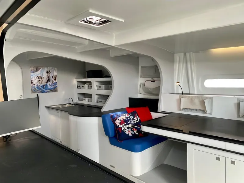 Slide: The Image of Modern yacht interior with sleek design, featuring a kitchen and seating area. Black Pepper Code 3, 2025. - 27