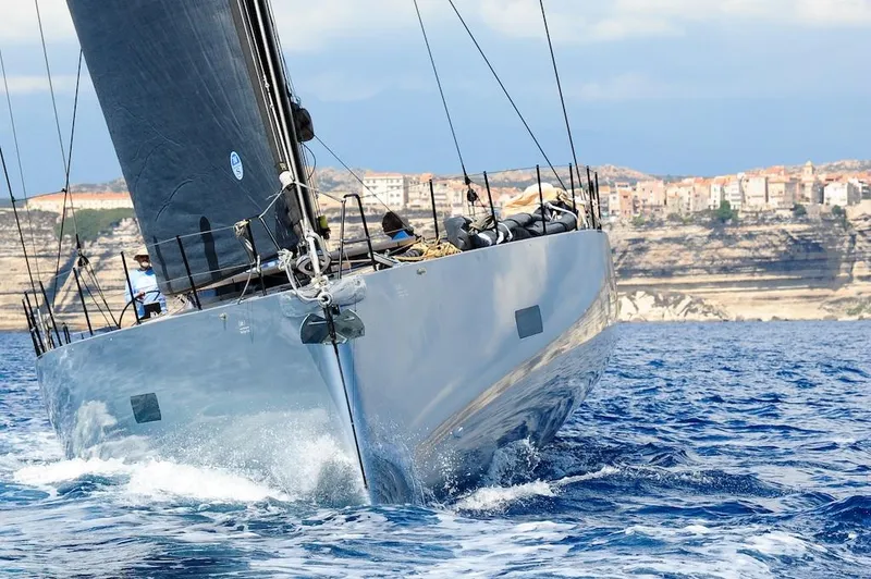 Slide: The Image of Sleek Black Pepper Code 3 yacht sailing near coastal cliffs, 2025 model. - 3