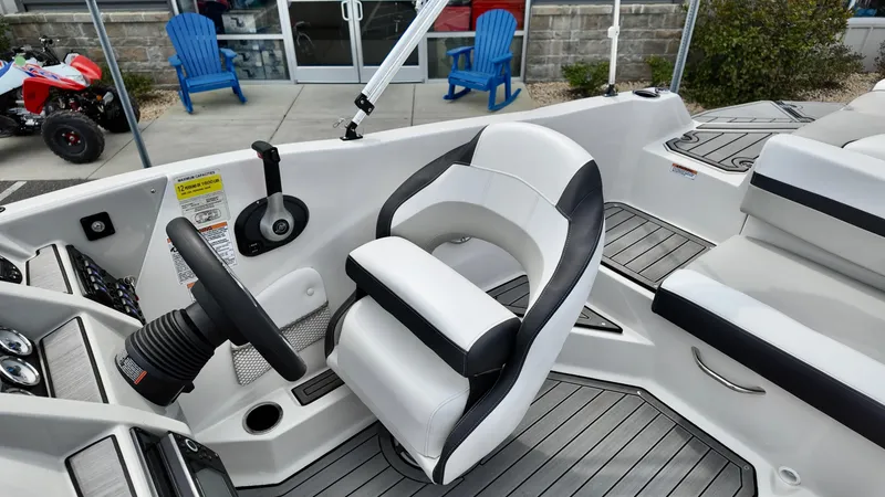 Slide: The Image of 2025 Starcraft SVX 211 IO boat interior with modern helm and seating. - 12
