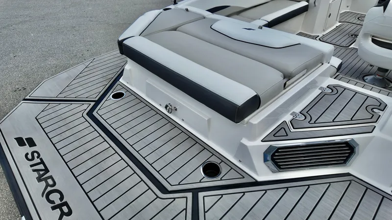Slide: The Image of 2025 Starcraft SVX 211 IO boat deck with cushioned seating and sleek design. - 6