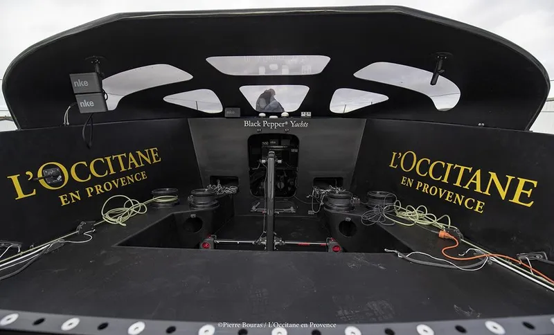 Slide: The Image of Cockpit of 2025 Black Pepper Imoca yacht with L'Occitane branding. - 8