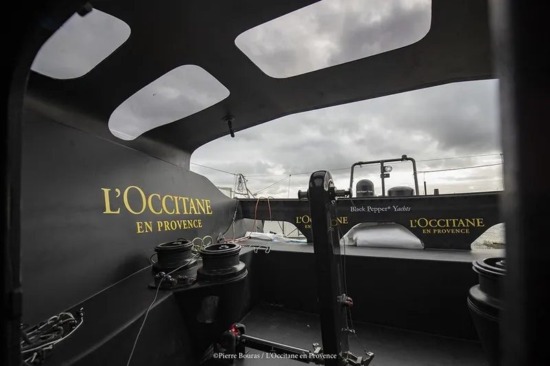 Slide: The Image of Sailing yacht interior with "L'Occitane en Provence" branding, Black Pepper Imoca 2025 model. - 9
