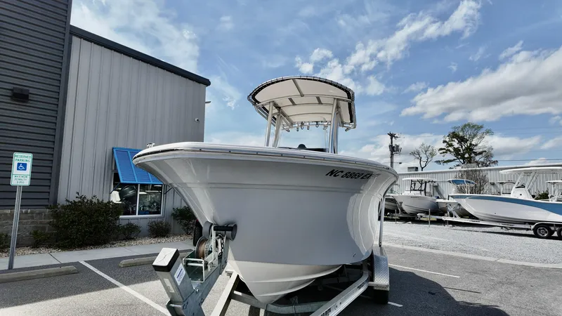 Slide: The Image of 2022 Sea Fox 228 Commander boat on trailer, parked outdoors under a blue sky. - 2