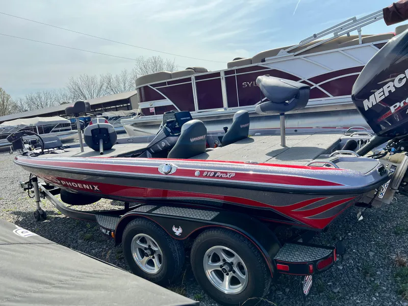 Slide: The Image of 2015 Phoenix 919 ProXP bass boat with dual seats and Mercury engine, parked on a trailer. - 3