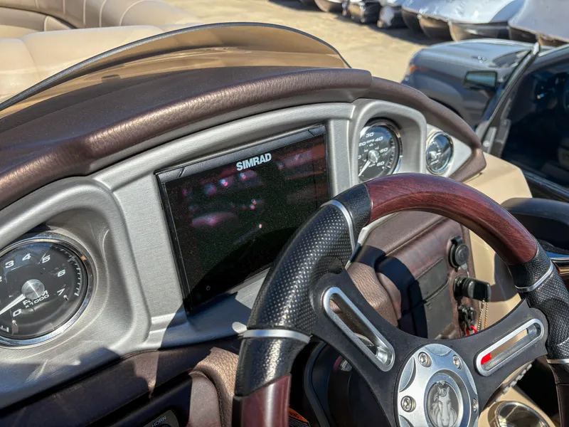 Slide: The Image of Dashboard of 2019 Trifecta 25 RF SS 3.0+ with Simrad display and steering wheel. - 5