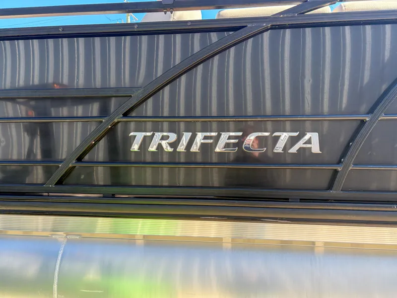 Slide: The Image of 2019 Trifecta 25 RF SS 3.0+ pontoon boat with sleek black exterior design. - 9